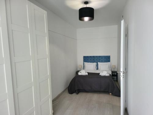 a bedroom with a bed with a blue headboard at HI Downtown Apartment A308 in Budapest