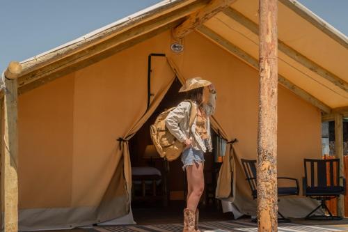 a man in a cowboy hat standing inside of a tent at Teton Peaks Resort in Tetonia