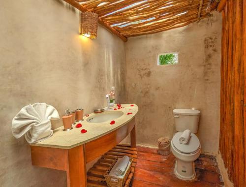 a bathroom with a sink and a toilet at Xhule Hotel Boutique in Tulum