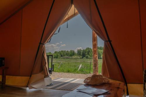 an orange tent with a view of a field at Teton Peaks Resort in Tetonia
