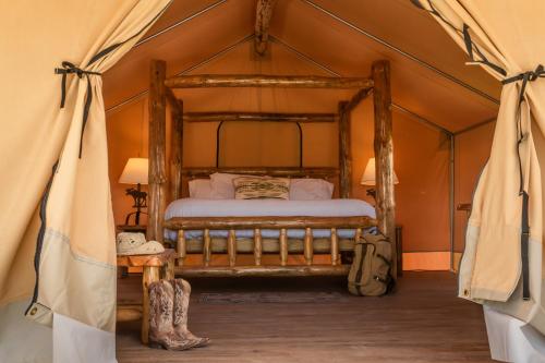 a bedroom with a bed in a tent at Teton Peaks Resort in Tetonia