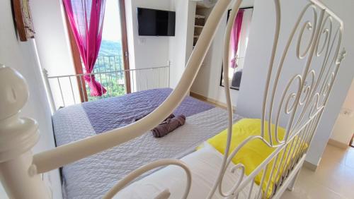 a swing bed in a bedroom with a balcony at STUDIO CASA FERMEGLIA for two people in Roč