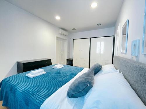 a bedroom with a bed with blue pillows on it at Apartment Candy in Pula