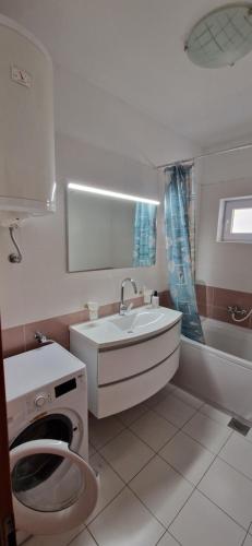 a white bathroom with a sink and a toilet at Holiday Retreat Apartment - Zadar in Zadar