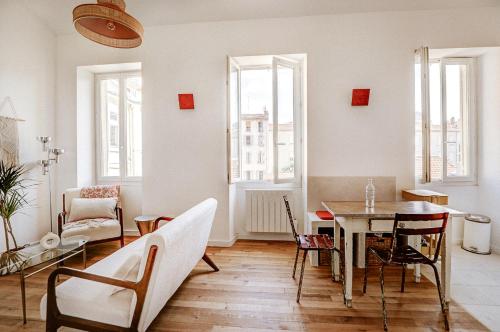 un salon avec une table et des chaises dans l'établissement Appartement T3 en duplex, Marseille 7, à Marseille