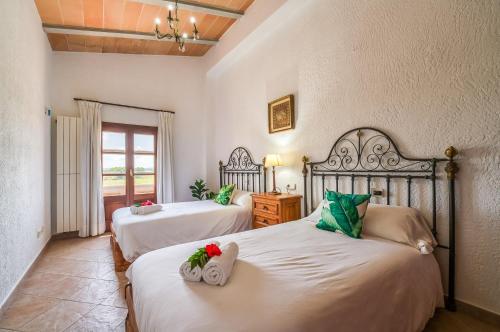 a bedroom with two beds with towels on them at Ideal Property Mallorca - Villa Gomila in Sa Pobla