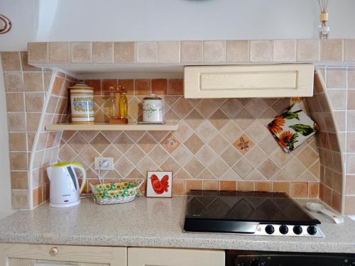 a kitchen with a stove and a counter top at Casa girasole in Isola del Giglio