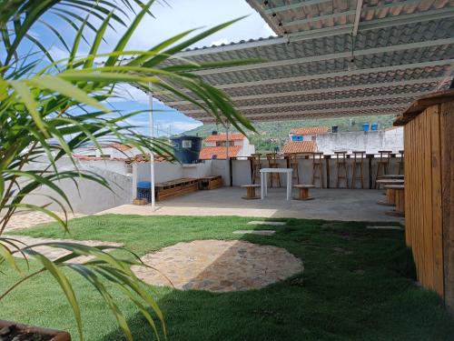 a patio with a table and benches on a roof at The Best Adventure Hostel in San Gil