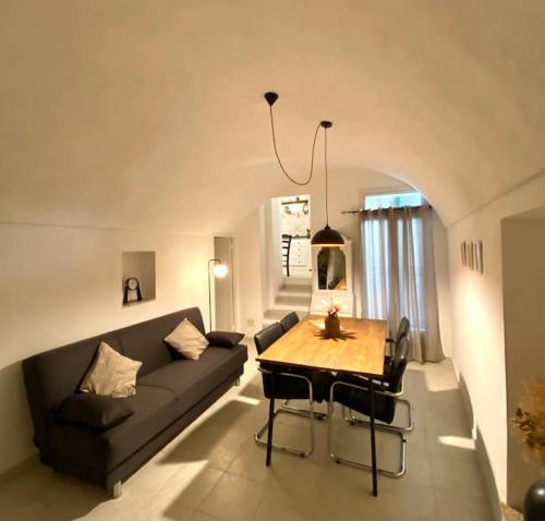 a living room with a couch and a table at Casa di Vincenzo in Airole