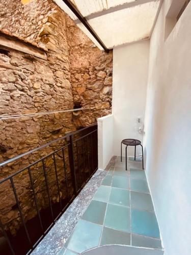 a room with a table and a chair on a floor at Casa di Vincenzo in Airole