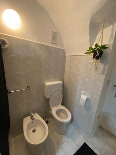 a bathroom with a toilet and a sink at Casa di Vincenzo in Airole
