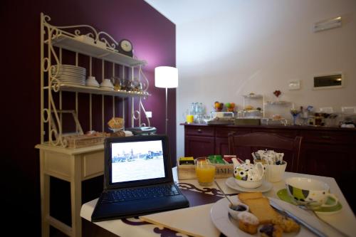 a laptop computer sitting on a table in a kitchen at Hotel Leon D'Oro in Mantova