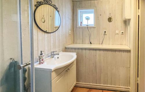 a bathroom with a sink and a mirror at Stunning Home In Ronneby With Kitchen in Ronneby