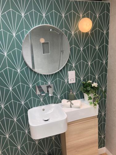 a bathroom with a sink and a mirror at Central ensuite guest unit with free on-street parking in Brighton & Hove