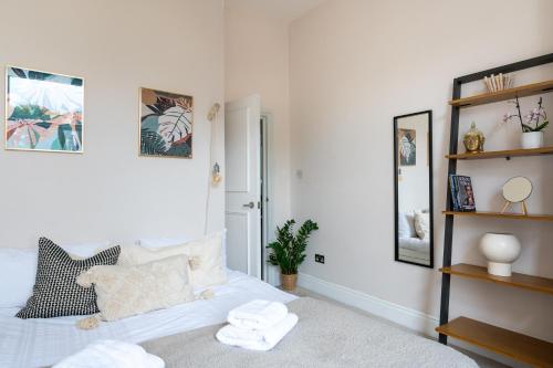 a bedroom with a bed with towels on it at Prime Location Cardiff Pontcanna Modern 2 Bedroom Apartment with Privat Parking in Cardiff