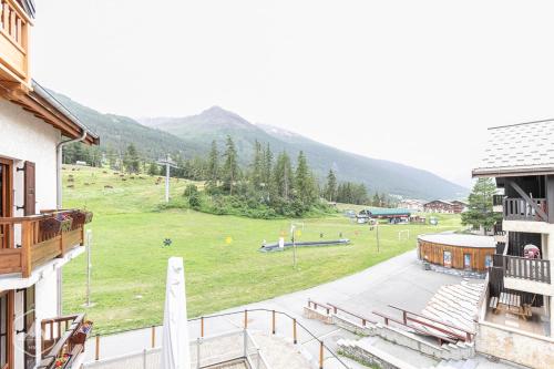 a view of a field from a balcony of a building at LES CHENEVERS in Lanslevillard