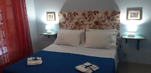 a bedroom with a bed with towels on it at Bellavista63 in Cefalù