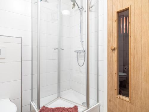 a shower with a glass door in a bathroom at Residenz "Zu den 3 Tannen" 5 in Zingst