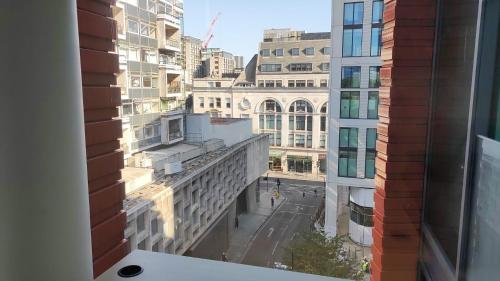 a view of a city street from a window at Spacious room in Central London in London