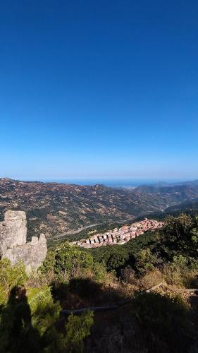a view of a village on a hill with the ocean at Artist's Home in Jerzu