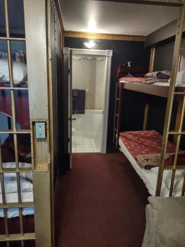 a room with two bunk beds and a bathroom at The King George Inn in Cobourg