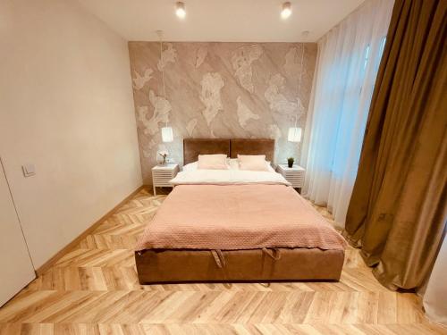 a bedroom with a large bed in a room at KOBIELA APARTMENTS Family Delux KTW City Center in Katowice
