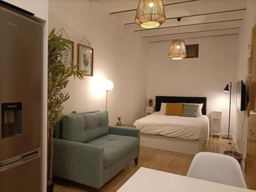 a living room with a bed and a couch at Piso NUEVO en centro de Madrid in Madrid