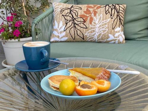 a table with a plate of food and a cup of coffee at B&B La mia Isola in Castelluzzo