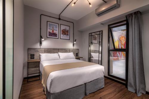 a bedroom with a large bed and a window at Up Barrio Norte in Buenos Aires