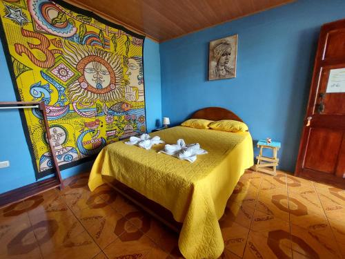 a bedroom with a yellow bed with flowers on it at Alojamientos N&S in Fortuna