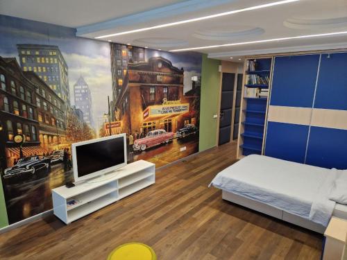 a bedroom with a tv and a mural of a city at STATUS Superior Apartments in Belgrade