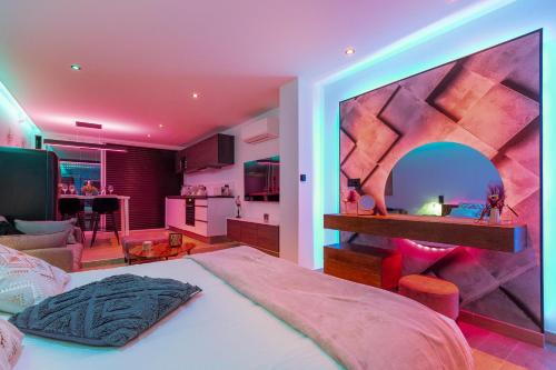 une chambre avec un grand lit et une cuisine dans l'établissement Village Naturiste R4N - Catalina Héliopolis Luxe, au Cap d'Agde