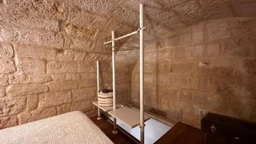 a bed in a room with a stone wall at Murat48 in Bari
