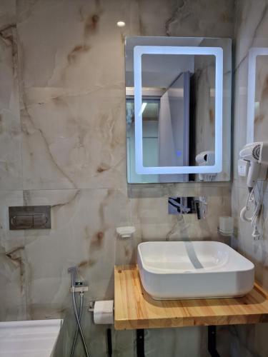 a bathroom with a sink and a mirror at Sea's Villa in Ksamil