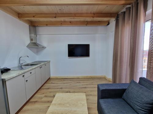 a kitchen and living room with a couch and a sink at Sea's Villa in Ksamil