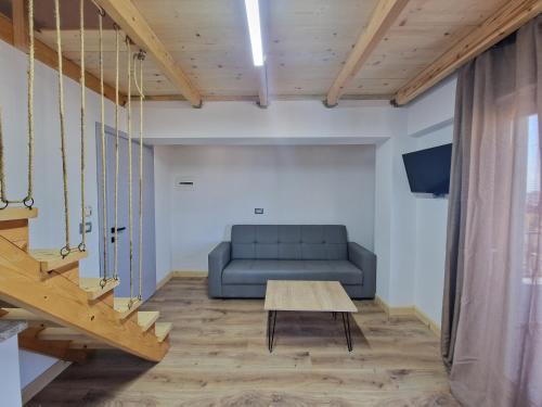a living room with a blue couch and a table at Sea's Villa in Ksamil