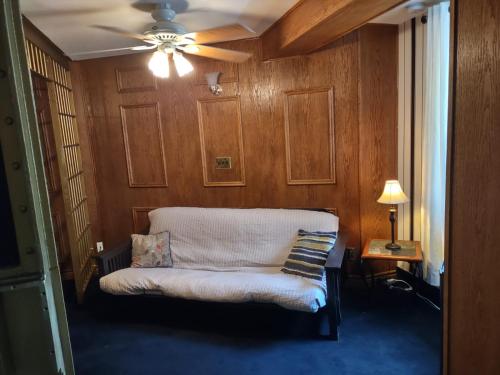 a living room with a couch and a ceiling fan at The King George Inn in Cobourg