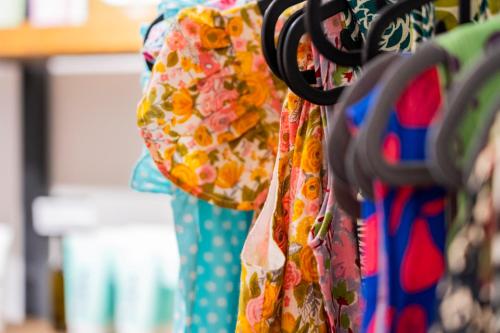 a bunch of dresses hanging from a pair of scissors at Anassa Cycladic Village in Galissas