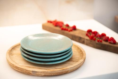 a stack of plates on a cutting board with strawberries at CeraMio Suites in Limenas