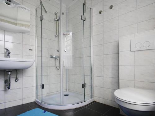 a bathroom with a shower and a toilet and a sink at holiday home, Plau am See in Plau am See