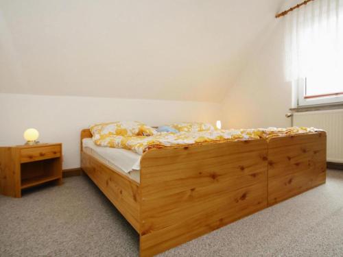 a bedroom with a wooden bed and a window at holiday home, Plau am See in Plau am See