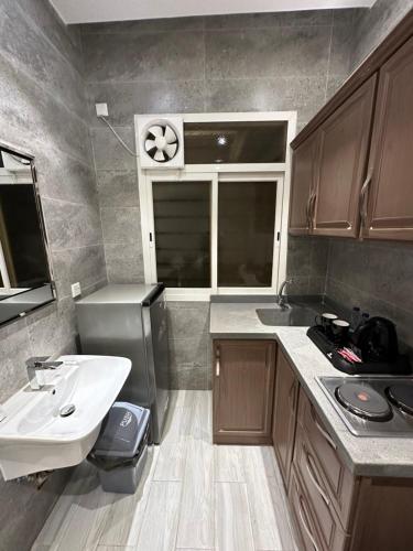 a small kitchen with a sink and a sink at Cast Home in Ahad Rafidah