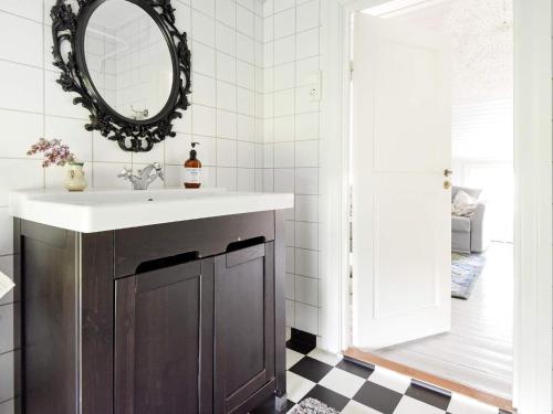 a bathroom with a sink and a mirror at 12 person holiday home in HOVA in Hova