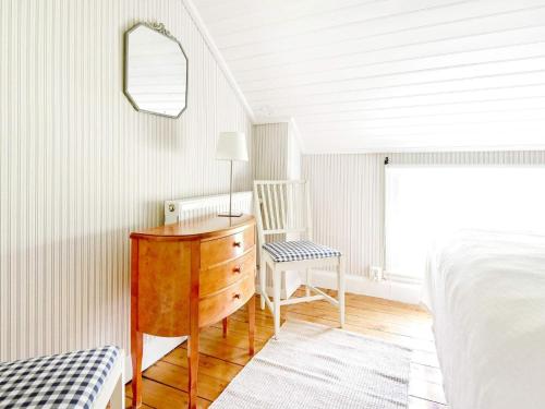 a bedroom with a desk and a chair and a bed at 12 person holiday home in HOVA in Hova