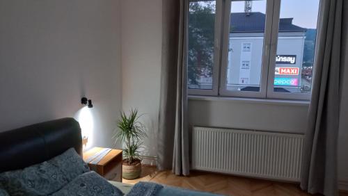 a living room with a couch and a window at Corso Residence in Bajina Bašta