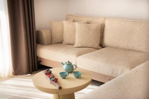 a living room with a couch and a table at CeraMio Suites in Limenas
