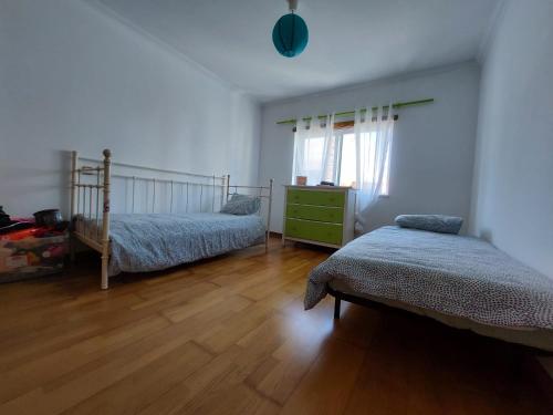 Кровать или кровати в номере A Family house in Santa Cruz, Torres Vedras