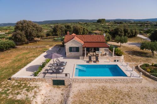 an aerial view of a house with a swimming pool at House Blato in Postira