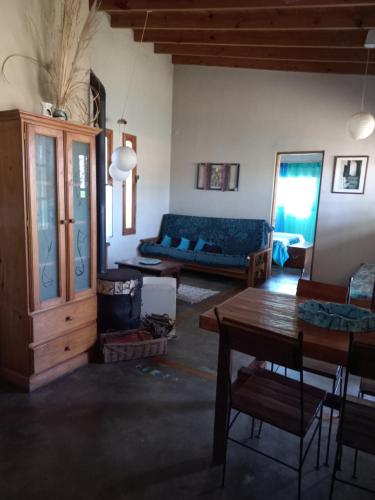 a living room with a blue couch and a table at Casas Piedra del Sol 2 in Costa del Este