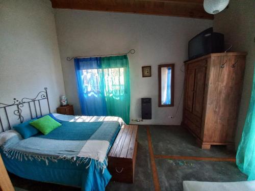 a bedroom with a bed and a dresser in it at Casas Piedra del Sol 2 in Costa del Este